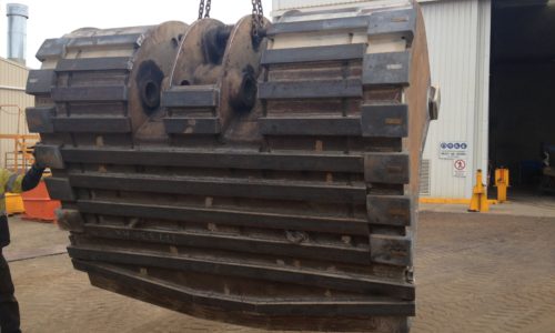 Underside view of conventional underground loader bucket with wear bars and heel blocks attached.