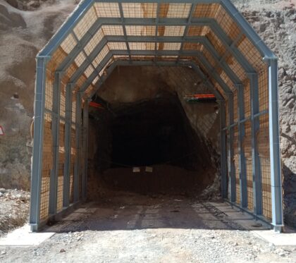 Looking through portal frame at entrance into underground mine