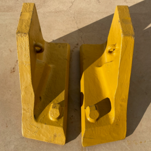 Cast corners to attach to lip on Sandvik underground loader bucket