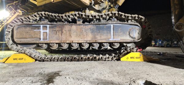 Bottom half of 800 tonne digger shown sitting on two stands in preparation for track roller maintenance. Stands are certified to support 400 tonne each.